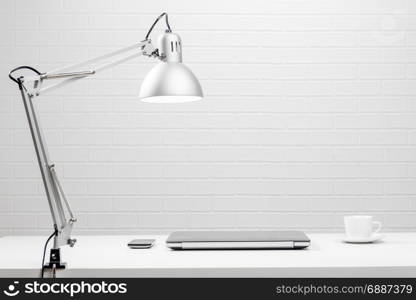 Empty workplace - white table and white brick wall