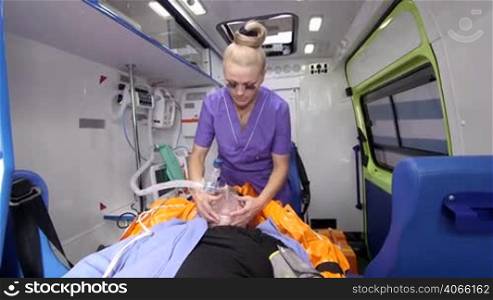 EMT provide emergency medical care for critical senior patient in ambulance and transport to the nearest hospital