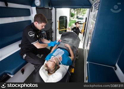 EMT worker feeling pulse in wrist of senior patient