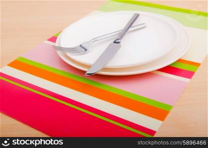 Emtpy plates with utensils on table
