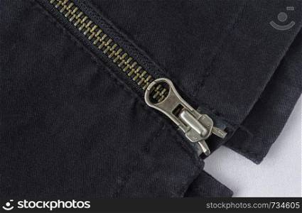 End of Closed Brass Zip on Black Jeans Texture Background. Closed Brass Zip on Black Jeans Texture Background for Apparel Design