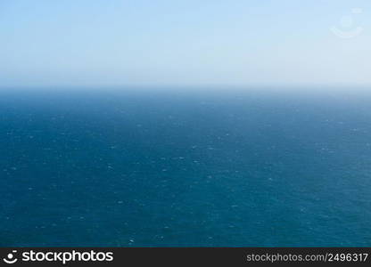 Endless deep blue ocean and sky horizon from birds eye