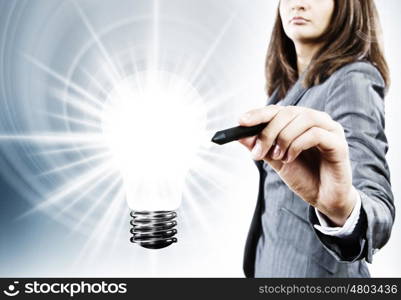 Energy concept. Close up of businesswoman touching light bulb