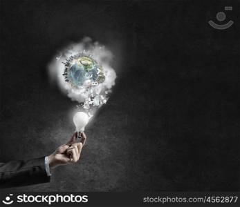 Energy saving. Businessman hand holding glowing light bulb. Elements of this image are furnished by NASA