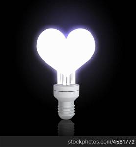 Energy saving concept. Glowing electrical light bulb on dark background