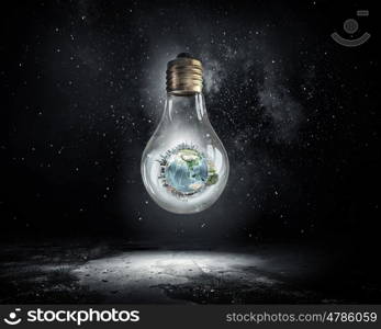 Energy saving concept. Planet Earth inside of light bulb. Elements of this image are furnished by NASA