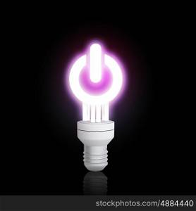 Energy saving concept. Power concept with light bulb glowing on dark background