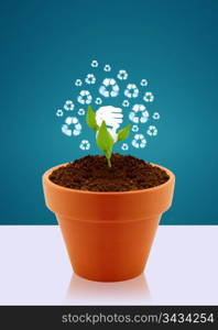 Energy saving fluorescent light bulb as flower in garden pot, Ecological awareness concept