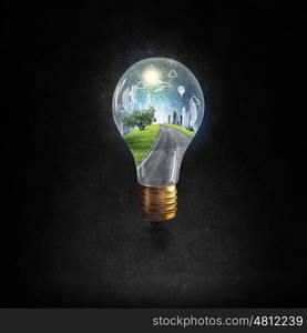 Energy saving. Think green concept with cityscape inside of light bulb