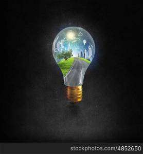 Energy saving. Think green concept with cityscape inside of light bulb