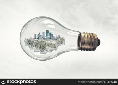 Energy saving. Think green concept with modern cityscape inside of light bulb
