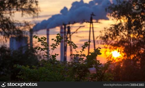 Energy. Smoke from chimney of power plant or station at the sunset. Industrial landscape.