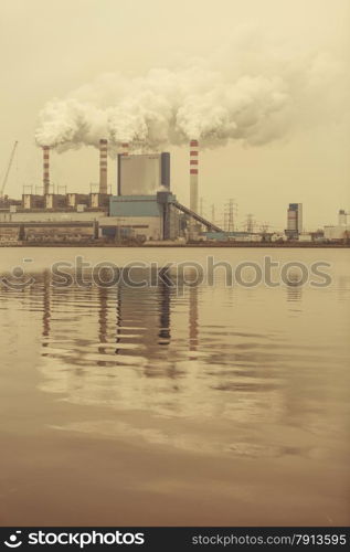 Energy. Smoke from chimney of power plant or station. Industrial landscape. Autumnal foggy day