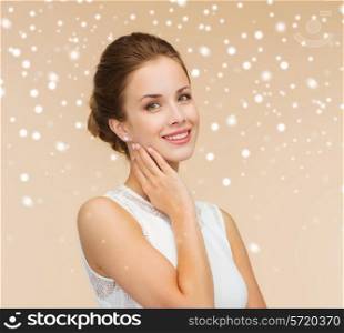 engagement, celebration, wedding and happiness concept - smiling woman in white dress wearing diamond ring over beige background and snow