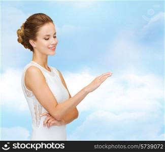 engagement, celebration, wedding and people concept - smiling woman in white dress wearing diamond ring over blue cloudy sky background