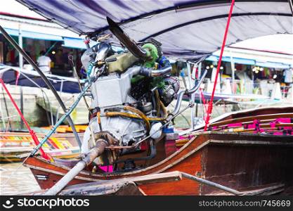 Engine on a longtail boat of amphawa floating market is the tourist most popular in Samut Songkhram, thailand.