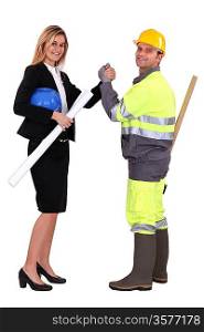 Engineer and a construction worker making a pact