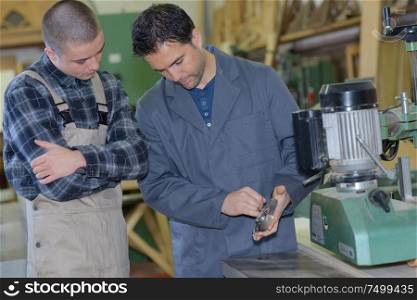 engineer and apprentice planning cnc machinery project