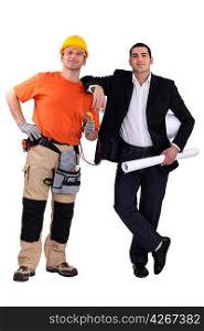 Engineer and construction worker standing side by side