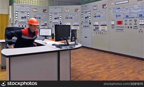 engineer approaches main control shield of gas compressor station, checks LEDs and returns to workplace