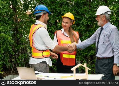Engineer, architect and business man working on the engineering project at construction site. House building concept.