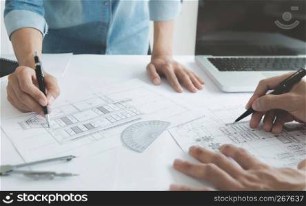 engineer architects discussing on the table with blueprint