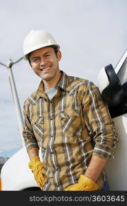 Engineer by van at wind farm, portrait