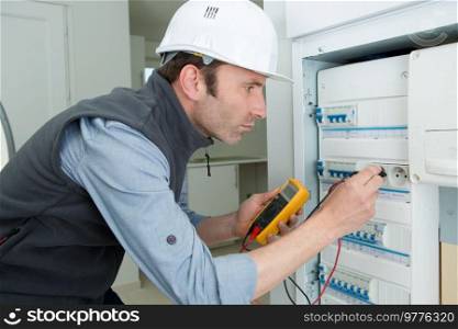 engineer checking the electrical cabinet at control room