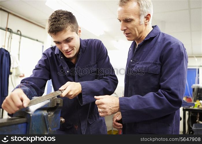 Engineer Checking Trainee&#39;s Work On Factory Floor