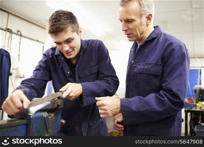 Engineer Checking Trainee&#39;s Work On Factory Floor