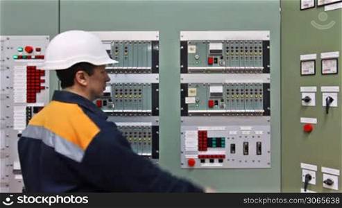 engineer comes to checking light indication on panel controls of gas in premises