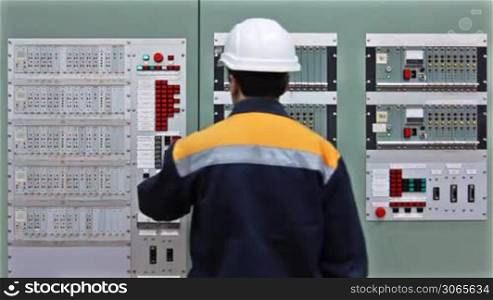 engineer comes to checking light indication on two control panels and leaves