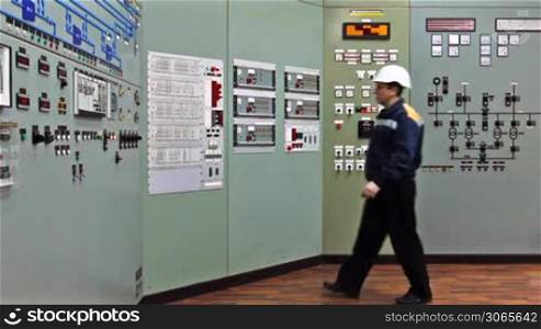 engineer comes to checking light indication on two control panels, wide viewing