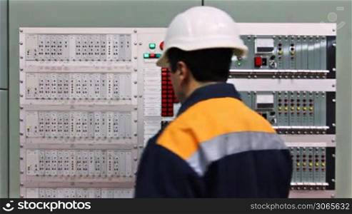 engineer comes to fire fighting control panel and check light indication, closeup