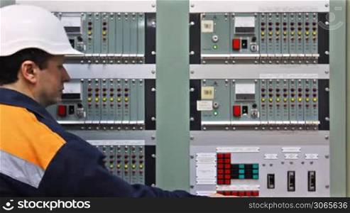 engineer comes to panel controls of gas in premises and check light indication, closeup