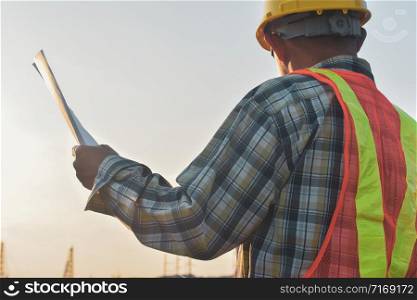 Engineer construction holding paper blueprint inspection building estate construction project