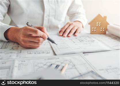 Engineer drawing graphic planning working with architectural project on workplace office.