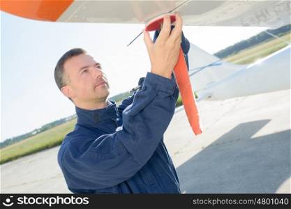 engineer fixing an airplane wing