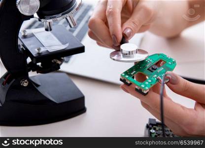Engineer fixing broken computer hard drive