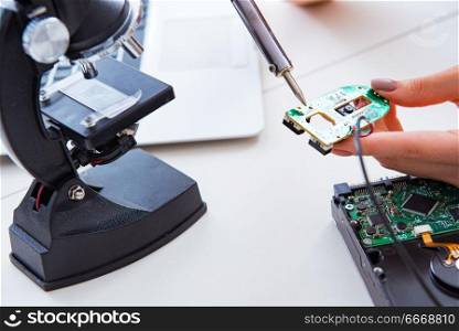 Engineer fixing broken computer hard drive