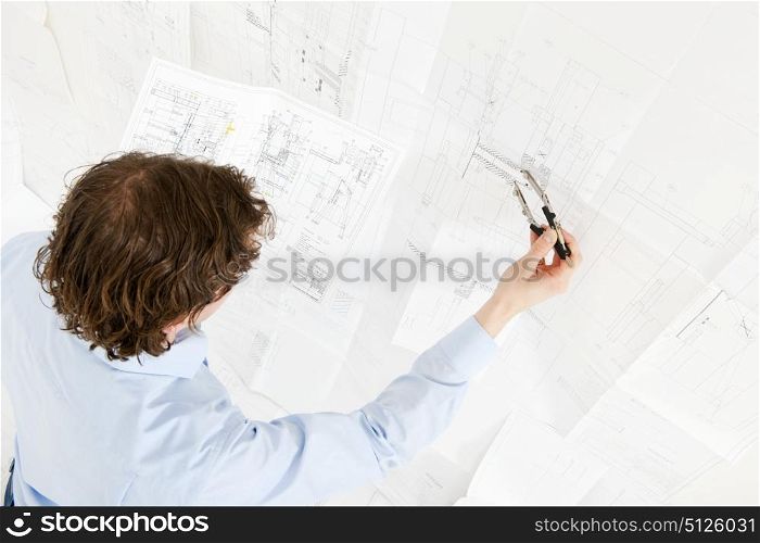 Engineer going over the revisions of a complex technical drawing