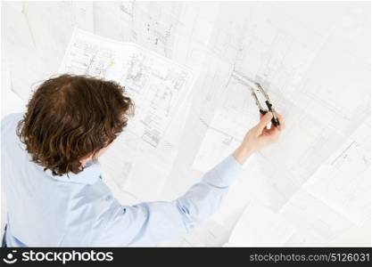 Engineer going over the revisions of a complex technical drawing