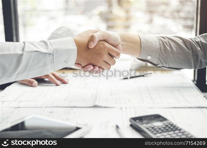 Engineer handshake meeting for architectural project and working with partner engineering on workplace