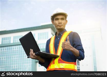 Engineer holding Computer Notebook for work and Sky technology background