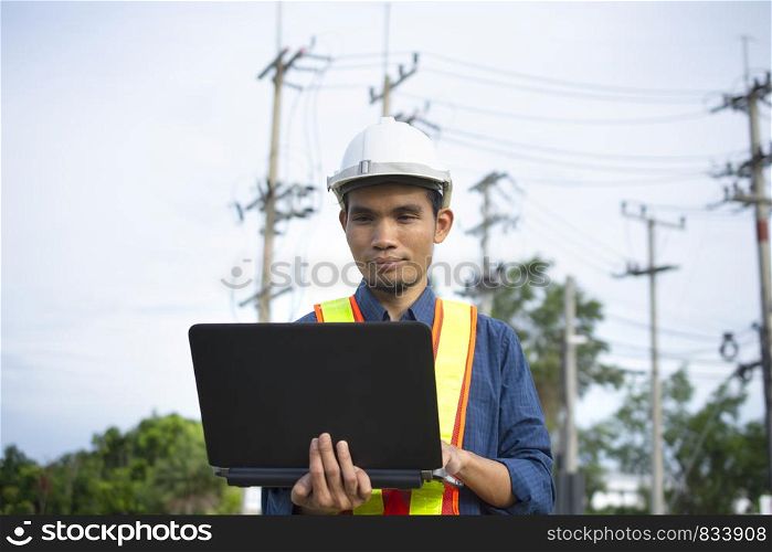 Engineer holding computer working on side technology