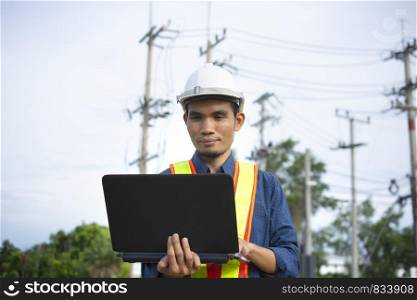 Engineer holding computer working on side technology