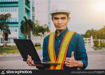 Engineer holding computer working on side technology Building construction