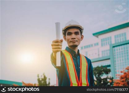Engineer holding paper factory plant background