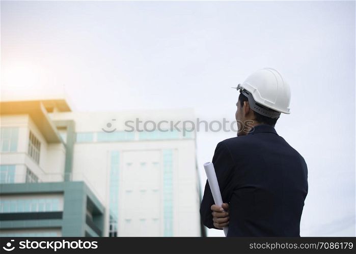 Engineer Holding paper plan and building Sky Background