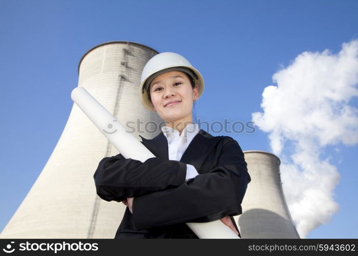 Engineer in front of cooling towers